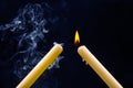 Lighting a candle with a wooden match on a dark background. Burning candle fire Royalty Free Stock Photo