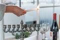 Lighting of candles for Hanukkah holiday. Royalty Free Stock Photo