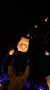 Lighting candles, lanterns in the sky at night in the Lantern Festival