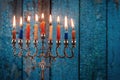 Lighting candles in menorah for Hanukkah Royalty Free Stock Photo