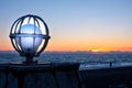 Lighting of the embankment in the form of a ball. ball lamp on the seashore close-up during sunset. background blurred, silhouette Royalty Free Stock Photo