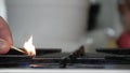 Lighting the Flame of the Kitchen Stove Opening the Gas and Using a Lit Match. Man Starting the Calor Gas Using Matches.