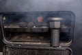 Lighting a home grill with a battery blower, standing in the backyard. Royalty Free Stock Photo