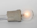 Lighting incandescent lamp bulb with cap, socket, wires lies on white background, new idea concept Royalty Free Stock Photo