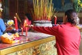 Lighting incense sticks at Buddhist temple
