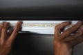 Lighting install,the master makes the installation of LED strip on the upper niches of the cabinet at home