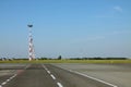 Lighting masts by a take-off runway of an airport