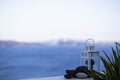 Lighting old white lamp on a blue coastal sea landscape in Santorini