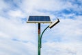 Lighting pole activated with an attached blue solar panel in Parcul Izvor Izvor Park in Bucharest, Romania, with cloudy sky in Royalty Free Stock Photo