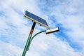 Lighting pole activated with an attached blue solar panel in Parcul Izvor Izvor Park in Bucharest, Romania, with cloudy sky in Royalty Free Stock Photo