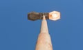 Lighting pole with a lighted lamp Royalty Free Stock Photo