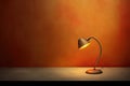 lighting retro desk lamp on old wood table with space of rough cement wall in vintage color tone Royalty Free Stock Photo