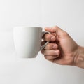 Lighting is soft, creating subtle shadows on the hand and mug, Royalty Free Stock Photo