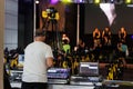 Lighting and Sound Technician and Broadcast Operator at Work in the BackStage during a Public Event