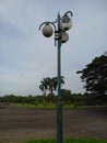 Lighting steetlight green iron light tree vehicle mast branch wall blue wind wing electricty sculpture sky art reflection glass Royalty Free Stock Photo