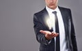 Lighting the way to sustainable business practices. A businessman holding a glowing light bulb. Royalty Free Stock Photo