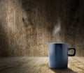 Lighting from window with hot blue coffee cup in hardwood room w Royalty Free Stock Photo