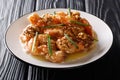 Lightly fried shrimp, sweet creamy sauce and candied walnuts close-up on a plate. horizontal Royalty Free Stock Photo