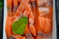 Lightly salted fish salmon in the form of slicing and a leaf of curly mint on top. Royalty Free Stock Photo