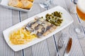 Lightly salted herring filets with pickled cabbage, canned peas and onion Royalty Free Stock Photo