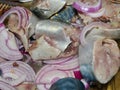 Lightly salted mackerel with red onion according to a homemade recipe. A natural and healthy product. Valuable commercial fish.