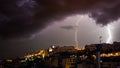 Cagliari panorama at night with lightning strikes behind the city.