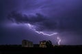 Lightning in big cloud over night city. Black stormy backdrop. Thunderstorm weather. Sky clouds. Dark dramatic scene Royalty Free Stock Photo