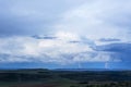 Lightning from the blue clouds to the green hills