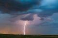 Lightning bolt and storm clouds at sunset Royalty Free Stock Photo