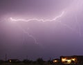 A Lightning Bolt Streaks Above a Neighborhood Royalty Free Stock Photo