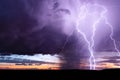 Lightning strike from a powerful storm at sunset. Royalty Free Stock Photo