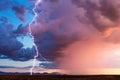 Lightning bolt strike from a storm at sunset Royalty Free Stock Photo