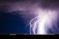 Lightning bolt strike from a thunderstorm over a city Royalty Free Stock Photo