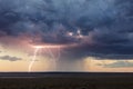 Lightning strike from a thunderstorm at sunset Royalty Free Stock Photo