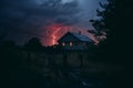 a lightning bolt strikes a house in the middle of the night Royalty Free Stock Photo