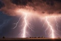 lightning bolts bolt across the sky over a field in an image of an industrial area