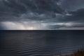 Lightning bolts reflection over the sea. taken during a thunderstorm over the ocean with clouds in the background Royalty Free Stock Photo