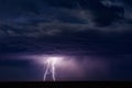 Lightning bolts strike from a thunderstorm at night. Royalty Free Stock Photo
