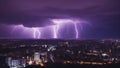 lightning city skyline at night is lit up by a purple hue multiple lightning strikes, creating a dramatic and futuristic scene.