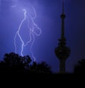 Lightning and communication tower in stormy night Royalty Free Stock Photo