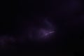 Lightning discharges in stormy sky under dark rain clouds at night Royalty Free Stock Photo