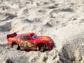 Lightning McQueen toy model car on sand Royalty Free Stock Photo