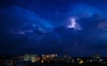 Lightning in the night sky over the city. Summer thunderstorm Royalty Free Stock Photo