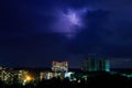 Lightning in the night sky over the city. Summer thunderstorm Royalty Free Stock Photo