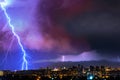 Lightning over the city at the summer storm. Dramatic, breathtaking atmospheric natural phenomenon. Royalty Free Stock Photo