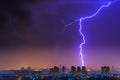 Lightning over the city at the summer storm. Dramatic, breathtaking atmospheric natural phenomenon. Royalty Free Stock Photo