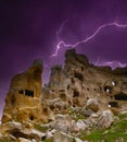 Lightning over the eroded remains of troglodyte cave housing