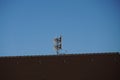 Lightning rod on the roof of a house with a blue sky on the background Royalty Free Stock Photo