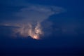 Lightning shines in the clouds above the sea Royalty Free Stock Photo