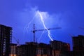 Lightning storm crane weather industrial city building construction night flash